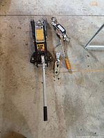 Full view of floor jack and hand winch hoist on workshop floor