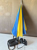 Binoculars, case and umbrella grouped together