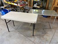 Two folding tables standing assembled