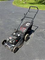 Full view of Yard Machines push mower with bag attached