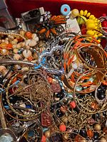 Close-up of mixed jewelry pieces showing variety of colors and materials