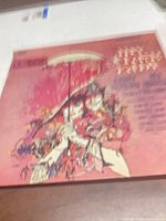 Front sleeve with Hirschfeld-style pink illustration and umbrella scene