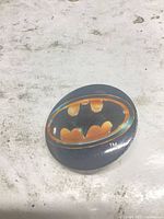 Front view of round Batman logo pinback button