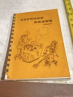 Front cover showing title, illustration, comb binding