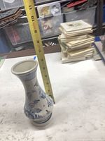 Vase beside measuring tape indicating roughly 9 inch height