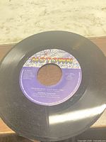 A-side label showing title, artist, catalogue number, surface scratches on vinyl