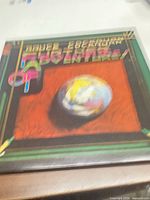 Front cover showing album title, artist name and globe artwork