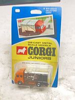 Front view of sealed Corgi Juniors blister card showing orange/black/silver truck