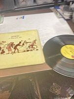 Front cover of Genesis A Trick of the Tail LP and record partially removed