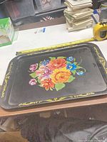 Full view of rectangular floral tole tray with tape measure for scale