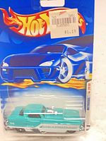 Front of blister card showing aqua/teal die-cast car and Hot Wheels branding
