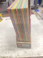 Side view of eight hardcover volumes in slipcase