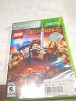 Front of Xbox 360 LEGO The Lord of the Rings game case sealed in protective sleeve