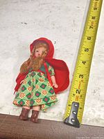 Full doll next to tape measure showing ~5 in height