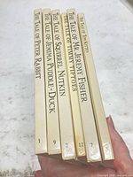 Six book spines showing titles and volume numbers