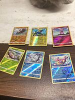 All six Pokémon holo cards laid out on table