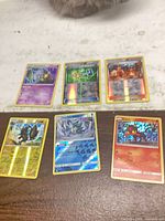 All six cards laid out showing fronts and foil patterns