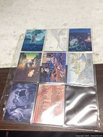Front view of 9 art promo cards in plastic sleeve