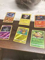 All six Pokemon cards laid out on table