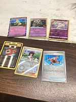 All six cards laid out; three Pokémon cards on top row, three Trainer cards on bottom row