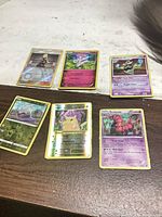 All six Pokémon cards laid out on tabletop