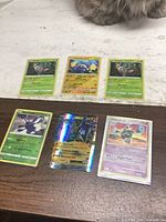 All six Pokémon cards laid out, three top three bottom
