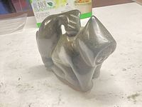 Front view of soapstone animal carving showing facial features and stance