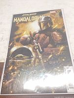 Front view of The Mandalorian #2 comic in bag and board