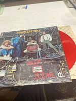Front cover with band photo and red vinyl partially visible
