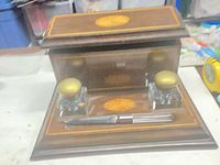 Open inkstand showing two glass inkwells and pen on base