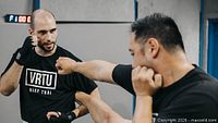 Instructor and student sparring wearing VRTU shirts