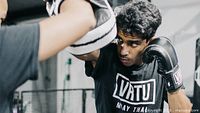 Student wearing VRTU gloves training with focus mitt