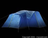 Full exterior view of blue Coleman Skydome XL tent with guy lines deployed