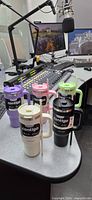 Five color variants of the Contigo tumblers on desk