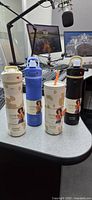Four Contigo x Ally Love bottles on desk