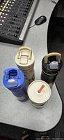Top view of all four insulated bottles showing lids and handles