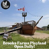 Outdoor pirate ship playground structure with Canadian flag at Brooks Farms Playland