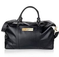 Front view of black Michel Germain vegan leather weekender bag showing handles, detachable strap, logo plaque, and zipper