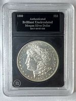 Obverse view of slab showing 1880-S Morgan silver dollar and label