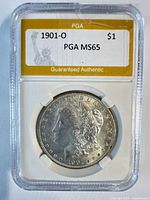 Obverse of 1901-O Morgan dollar in PGA slab, grade label visible