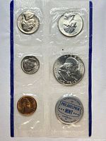 Front view of sealed Philadelphia Mint coin strip showing obverse sides of coins and blue token