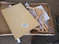 Main board and assorted wooden support pieces inside box