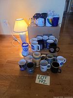 Full group of mugs and steins on floor showing quantity and variety