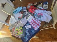 Overall lot showing towels, quilted pieces, doilies, ceramic items and tins