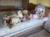 All plush animals arranged on mattress
