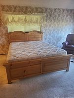 Queen pine bed frame with mattress in bedroom setting