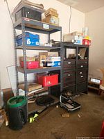 Overall view of shelving, drawer cabinets, creeper and contents