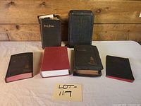 Six Bible volumes arranged, showing size comparison and covers