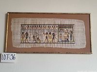 Full view of framed papyrus artwork in wood frame