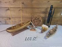 Overall lot showing all six carved wooden items